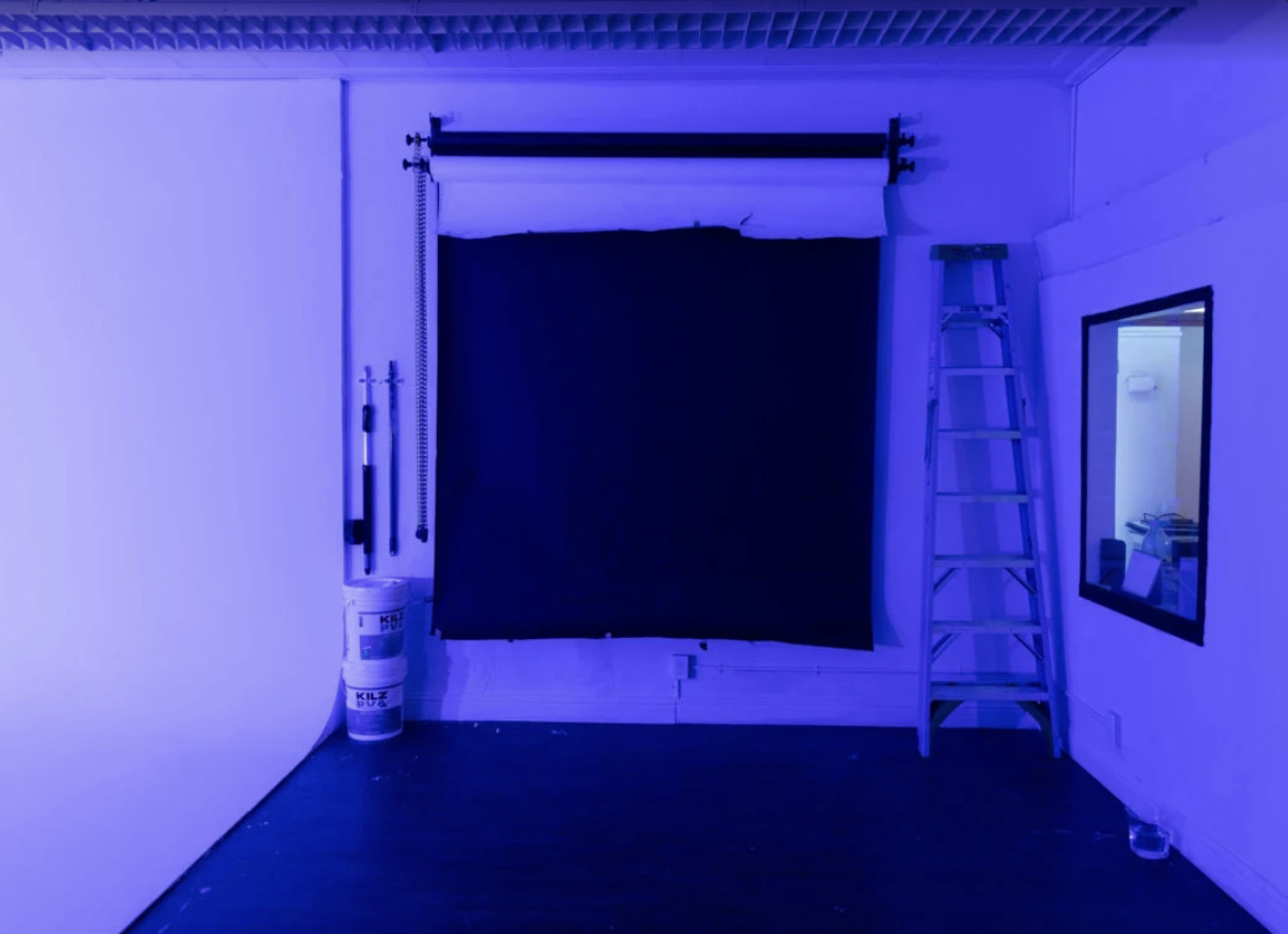 Blackout backdrop room with ladder and mounted seamless roll